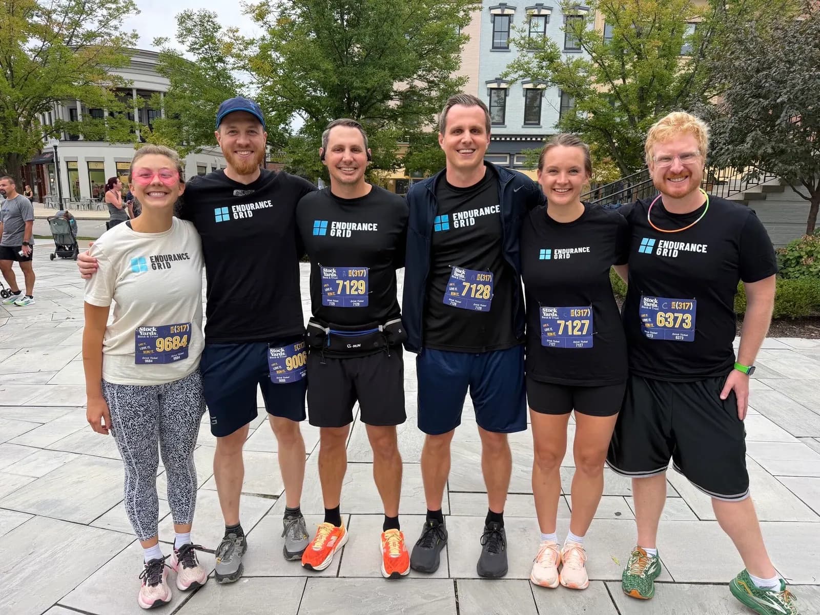 Six friends after a race in Endurance Grid shirts
